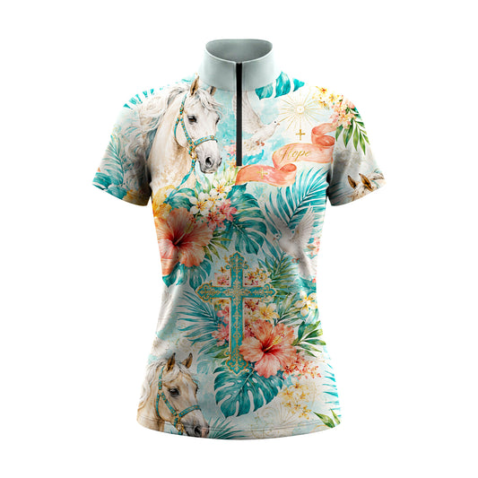 White background studio shot of pale aqua tropical hope ribbon white stallion hibiscus dove floral cross allover print short sleeve quarter zip riding top