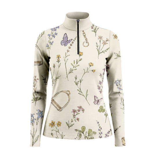 White background studio shot of soft cream watercolor wildflower butterfly stirrup chain allover print long sleeve quarter zip riding top