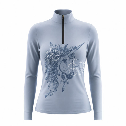 Close-up shot of model’s hand adjusting black half-zip stand collar of solid blue boho unicorn sketch long sleeve riding top in green grass pasture