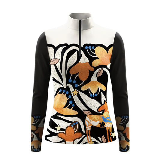 Warm sunlit stable side profile shot of model touching brown horse wearing black white color block folk art orange floral decorative horse long sleeve riding top