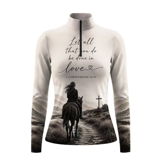 Model wearing muted monochrome spiritual mountain rider print riding top at outdoor equestrian show jumping arena with spectator stands