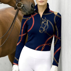 Model wearing heritage equestrian print riding top standing inside the stable at sunset