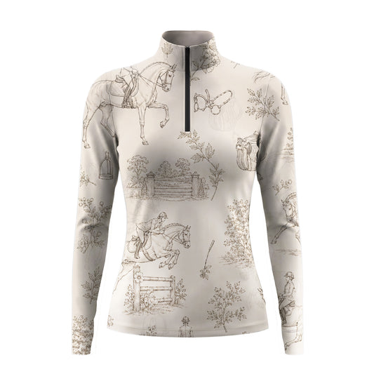 Studio shot of the RIDER ATELIER Beige Equestrian Toile De Jouy Print Long-Sleeve Quarter-Zip Riding Top, showing the full toile print, soft beige base, quarter-zip collar, and fabric texture against a clean white background