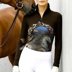 Woman wearing RIDER ATELIER ornate fantasy horse quarter-zip top at the stable