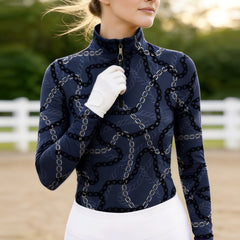 Woman wearing RIDER ATELIER luxury chain link quarter-zip top in the field at sunset