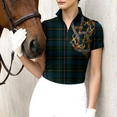 Woman wearing RIDER ATELIER tartan equestrian tack short sleeve quarter-zip top with a chestnut horse