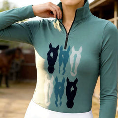 Woman wearing RIDER ATELIER teal stacked horse silhouette quarter-zip top at the stable
