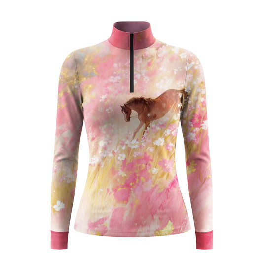 Studio shot of the RIDER ATELIER Watercolor Floral Horse Print Long-Sleeve Quarter-Zip Riding Top, showing the full watercolor floral horse print, gradient pink base, quarter-zip collar, and fabric texture against a clean white background