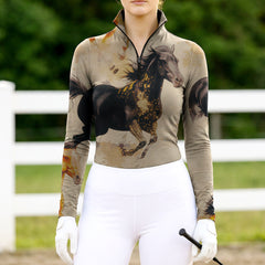 Woman wearing RIDER ATELIER watercolor galloping horse quarter-zip top at the outdoor pasture