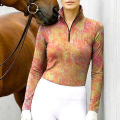 Woman wearing RIDER ATELIER watercolor snaffle bit quarter-zip top with a chestnut horse