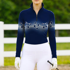 Woman wearing RIDER ATELIER wave snaffle bit quarter-zip top at the outdoor pasture