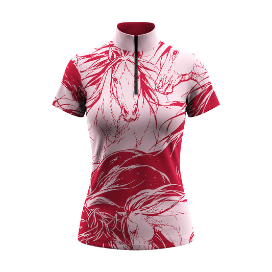 Model standing beside chestnut horse at sunlit dirt riding arena wearing high contrast red line art wild horse sketch short sleeve riding top