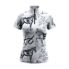 White background studio shot of white vintage toile horse & tack print short sleeve quarter zip riding top