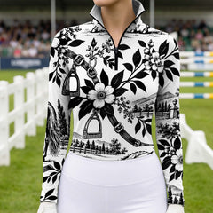 Torso view of the printed riding top worn by a rider standing in a show jumping arena