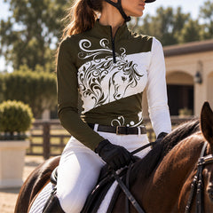 Rider wearing the brown horse print riding top seated in the saddle holding reins while riding a brown horse