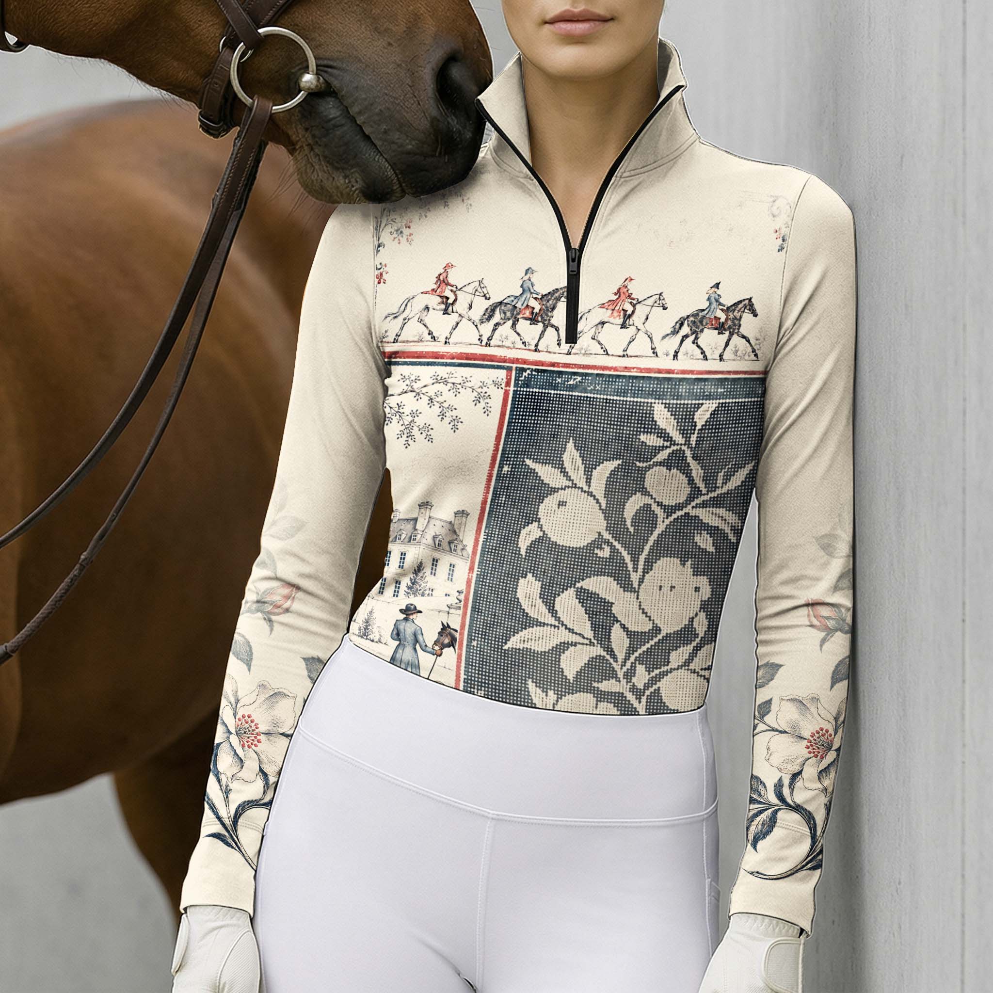 Model wearing the printed riding top next to a brown horse with a leather bridle against a light gray wall