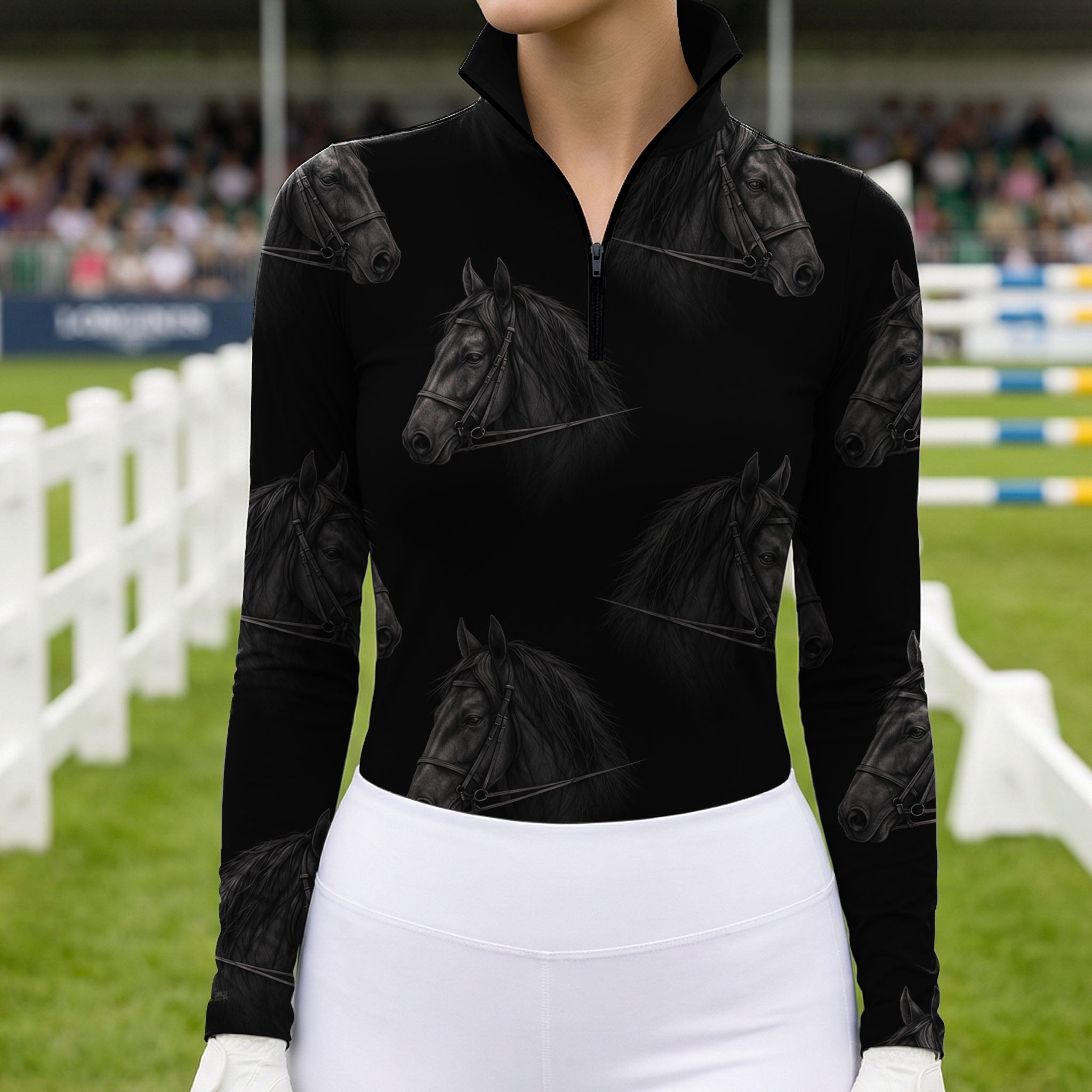 Model wearing a black long sleeve quarter zip riding top with dark gray horse head print in a show jumping arena