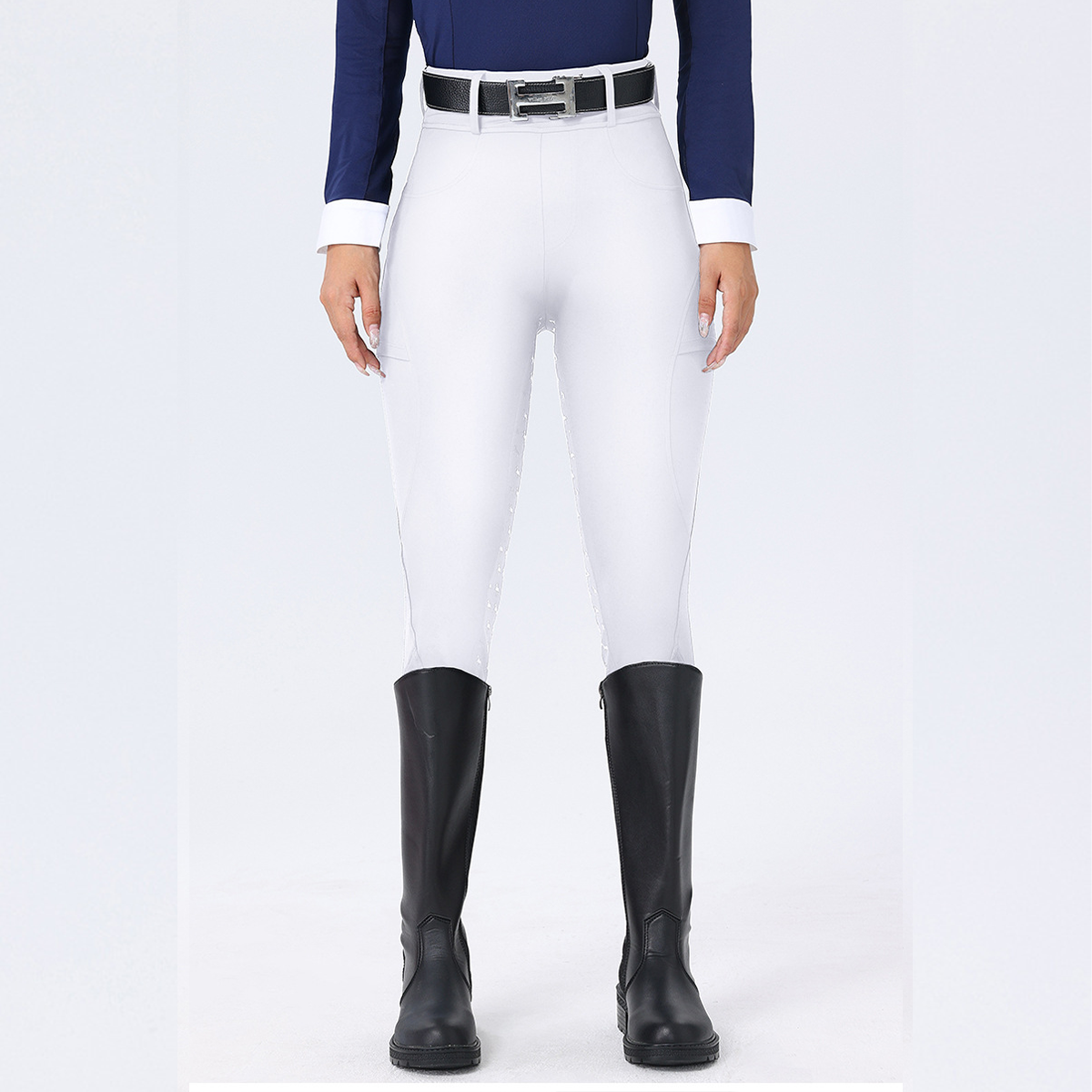 Person wearing white riding pants with black boots on a white background