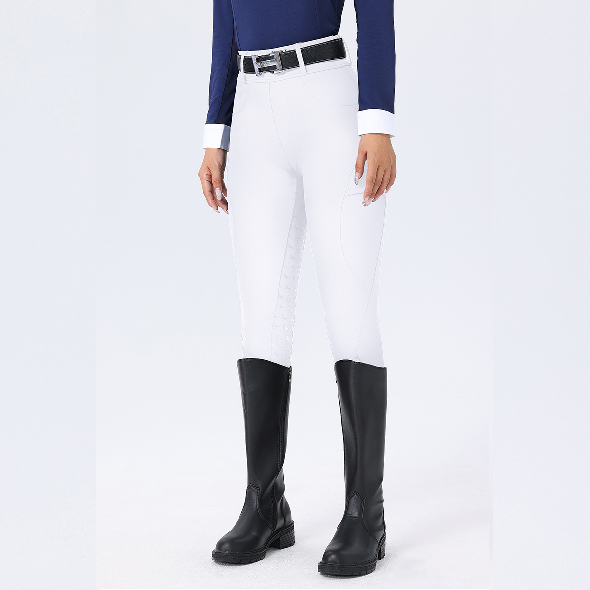 Person wearing white riding pants and black riding boots on a white background