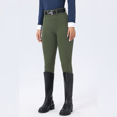 Person wearing green riding pants and black riding boots on a white background
