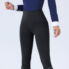 Person wearing black leggings with a blue top on a white background