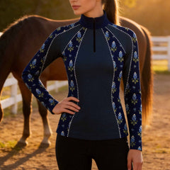 Clean white background studio product mockup of navy long‑sleeve quarter‑zip riding top with bluebonnet floral print and decorative rhinestone‑dot panel accents