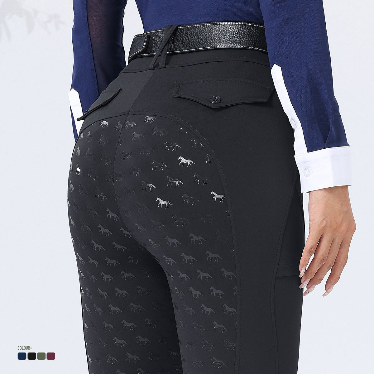 Black riding pants with horse pattern worn by a person on a white background