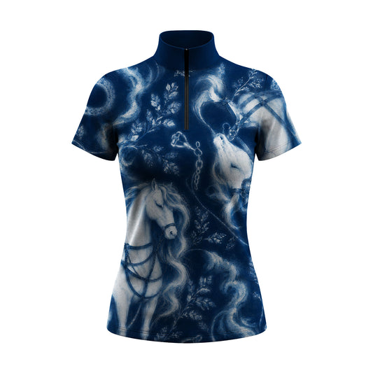 Indoor stable lifestyle shot of female equestrian in vintage cream painted horse botanical print short‑sleeve quarter‑zip riding top interacting with horse
