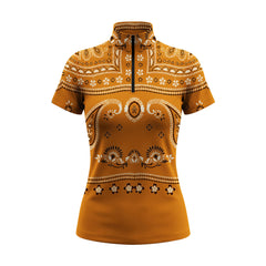 Studio white‑background product mockup of women’s burnt‑orange bandana paisley floral all‑over‑print short‑sleeve quarter‑zip riding top