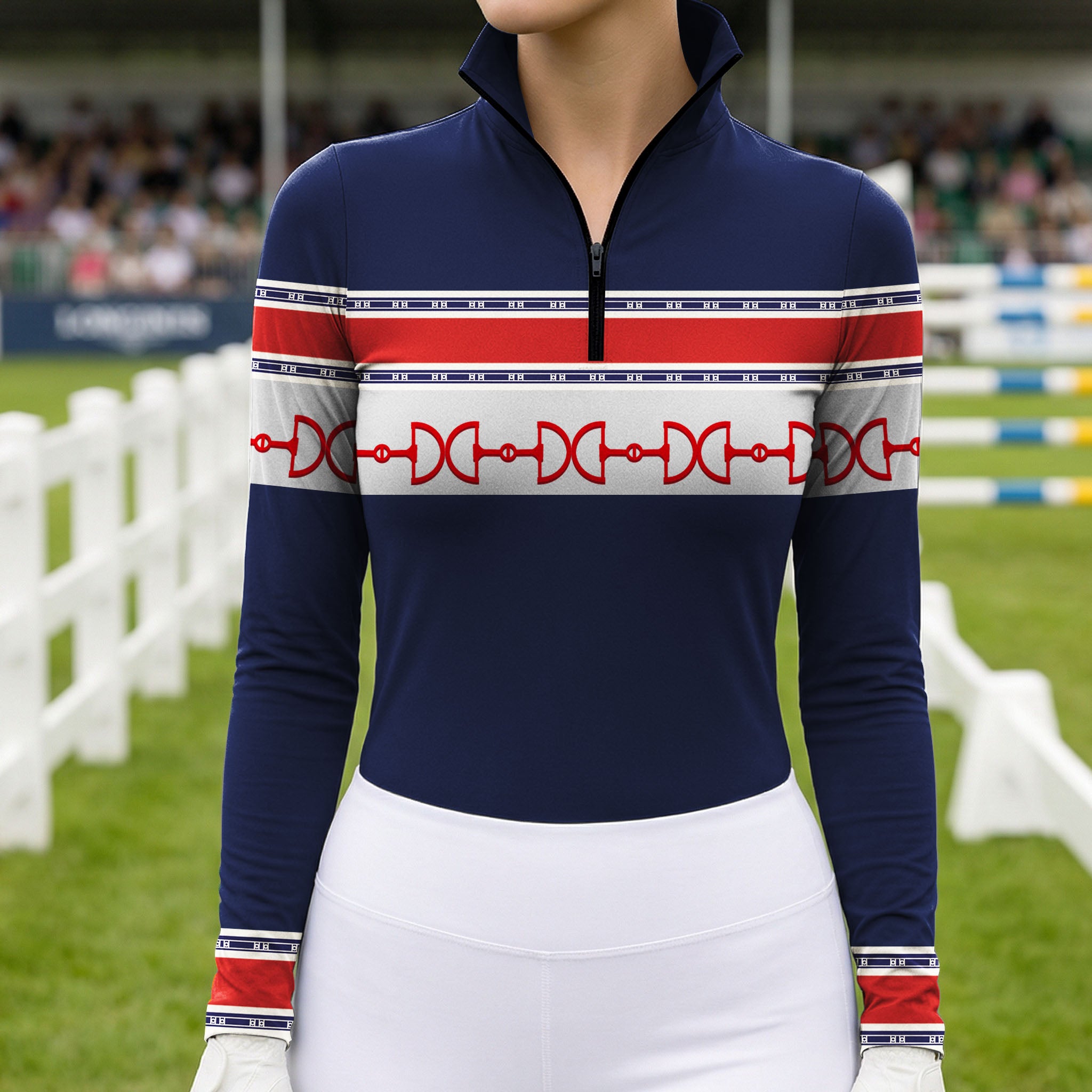 Outdoor grass show‑jumping arena lifestyle shot showcasing chest print detail of navy red‑white equestrian horse‑bit stripe long‑sleeve riding top with white breeches and riding gloves