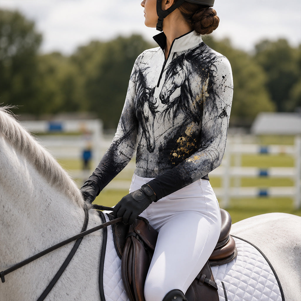 Outdoor equestrian venue riding shot of female rider on white horse wearing gradient dual‑horse art‑print long‑sleeve riding top