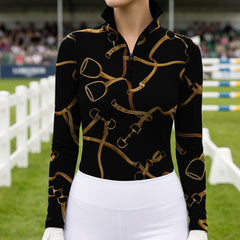 Equestrian‑show event close‑up shot of female equestrian wearing black golden bridle‑stirrup‑bit‑print long‑sleeve riding top