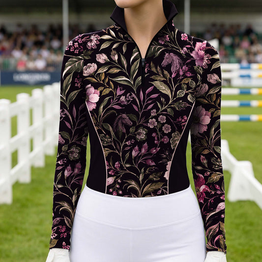 White background studio mockup of women’s black long‑sleeve quarter‑zip riding top with all‑over vintage purple floral and horse‑silhouette print, contrast piped side panels