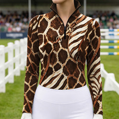 Grass show‑jumping event arena lifestyle shot showcasing print detail of giraffe‑zebra animal hide and faux leather harness graphic long‑sleeve riding top