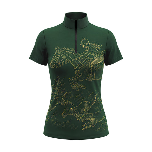 Outdoor equestrian arena model shot of rider in white breeches wearing black short‑sleeve quarter‑zip riding top with gold hunt‑scene artwork