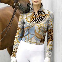 Clean white background studio product mockup of cream long‑sleeve quarter‑zip riding top with exclusive vintage equestrian tack zebra leopard mixed‑motif all‑over print