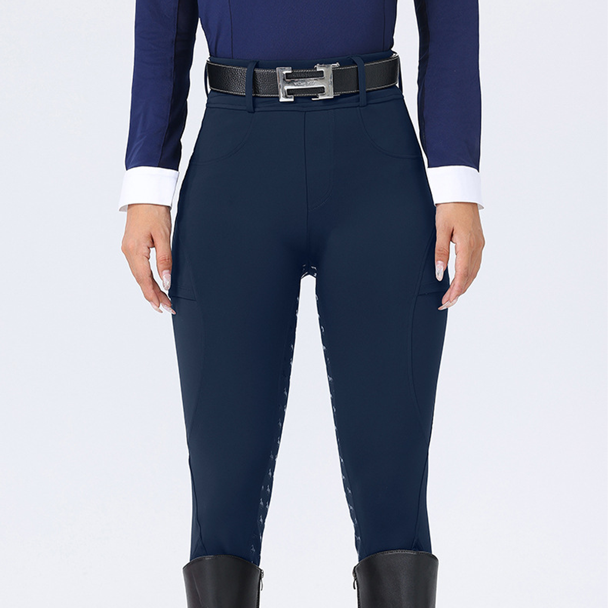 Navy riding pants with a belt on a white background
