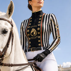 Show‑event close‑up detail shot of female rider wearing black‑white stripe vintage military‑inspired long‑sleeve quarter‑zip riding top and white riding breeches