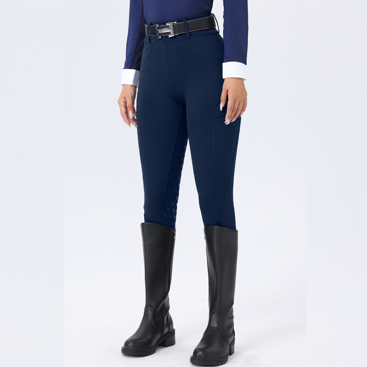 Navy riding pants with black boots on a white background