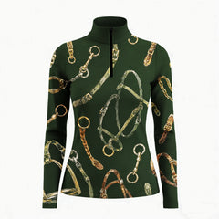 Studio white‑background product mockup of women’s forest‑green long‑sleeve quarter‑zip riding top with full watercolor horse‑tack hardware all‑over print