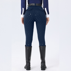 Person wearing navy riding pants with a pattern on a white background