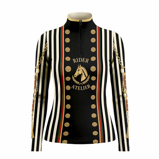 Show‑ground lifestyle shot of female equestrian leaning on white fence wearing black‑white stripe vintage military‑style graphic long‑sleeve riding top and white riding breeches with black riding gloves