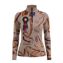 Outdoor equestrian arena back‑view lifestyle shot of female rider wearing charcoal vintage equestrian tack zebra leopard mixed‑print long‑sleeve riding top, paired with white riding breeches and white riding gloves