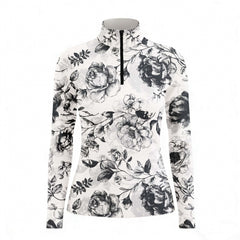 Studio white‑background product mockup of women’s off‑white sketch‑style dark peony floral long‑sleeve quarter‑zip riding top