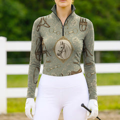 Model wearing antique tack print riding top at sunlit dirt equestrian arena