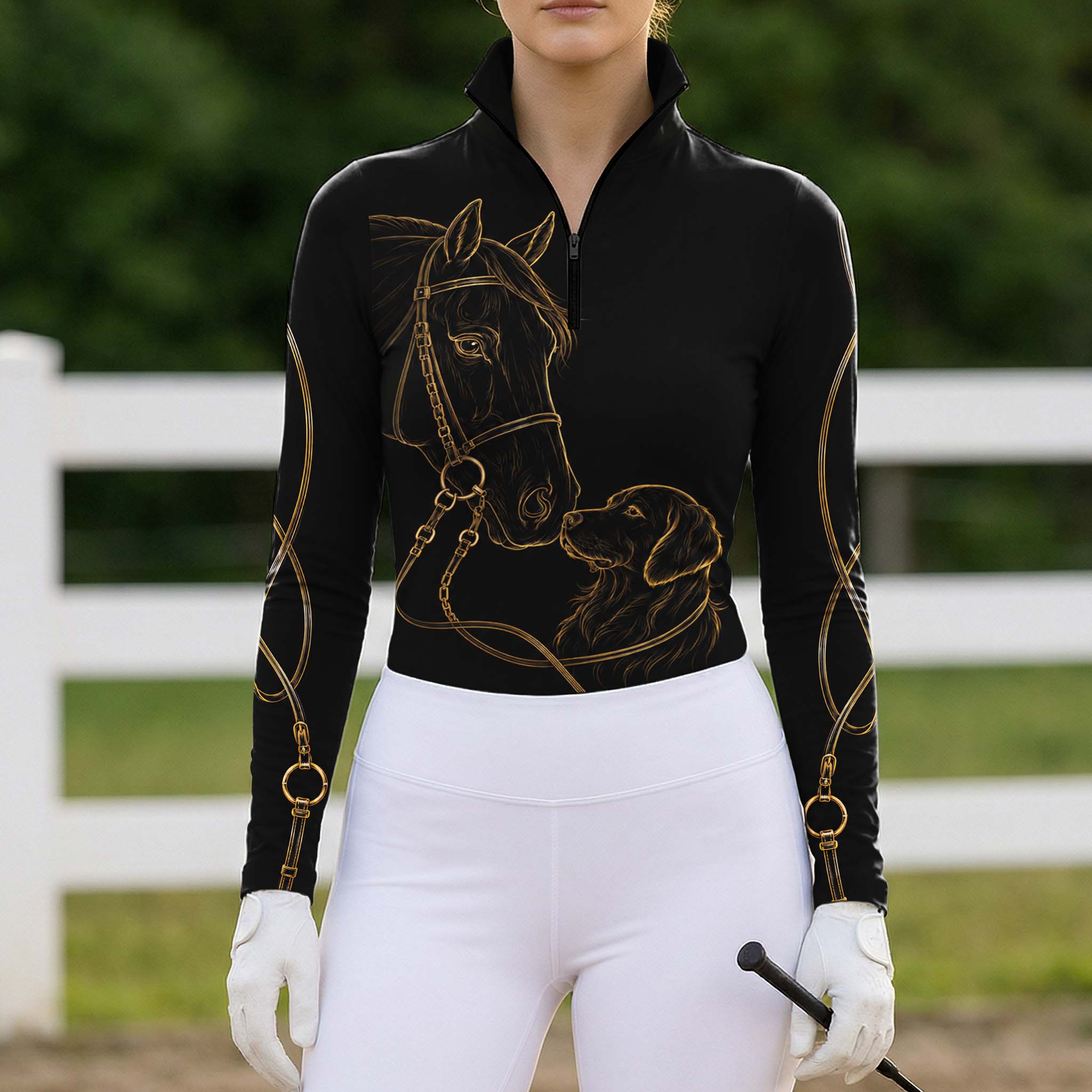 Model wearing sleek metallic gold sketch horse dog hardware long sleeve riding top at outdoor equestrian show jumping arena with spectator stands
