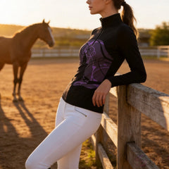 Golden sunset pasture wooden rail fence shot of female rider leaning on fence wearing black abstract purple line art sitting horse graphic long sleeve equestrian riding top