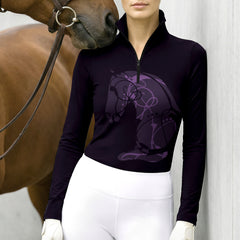 Neutral white wall shot of model beside brown horse wearing black abstract purple sitting horse line art print long sleeve quarter-zip riding top with white breeches