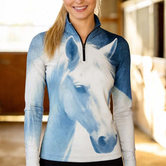 Front shot smiling model inside sunlit wooden horse stable wearing blue faded photorealistic white horse portrait long sleeve riding top