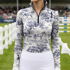 Equestrian show arena close‑up shot of rider in blue toile woodland‑horse‑scene‑pattern long‑sleeve riding top